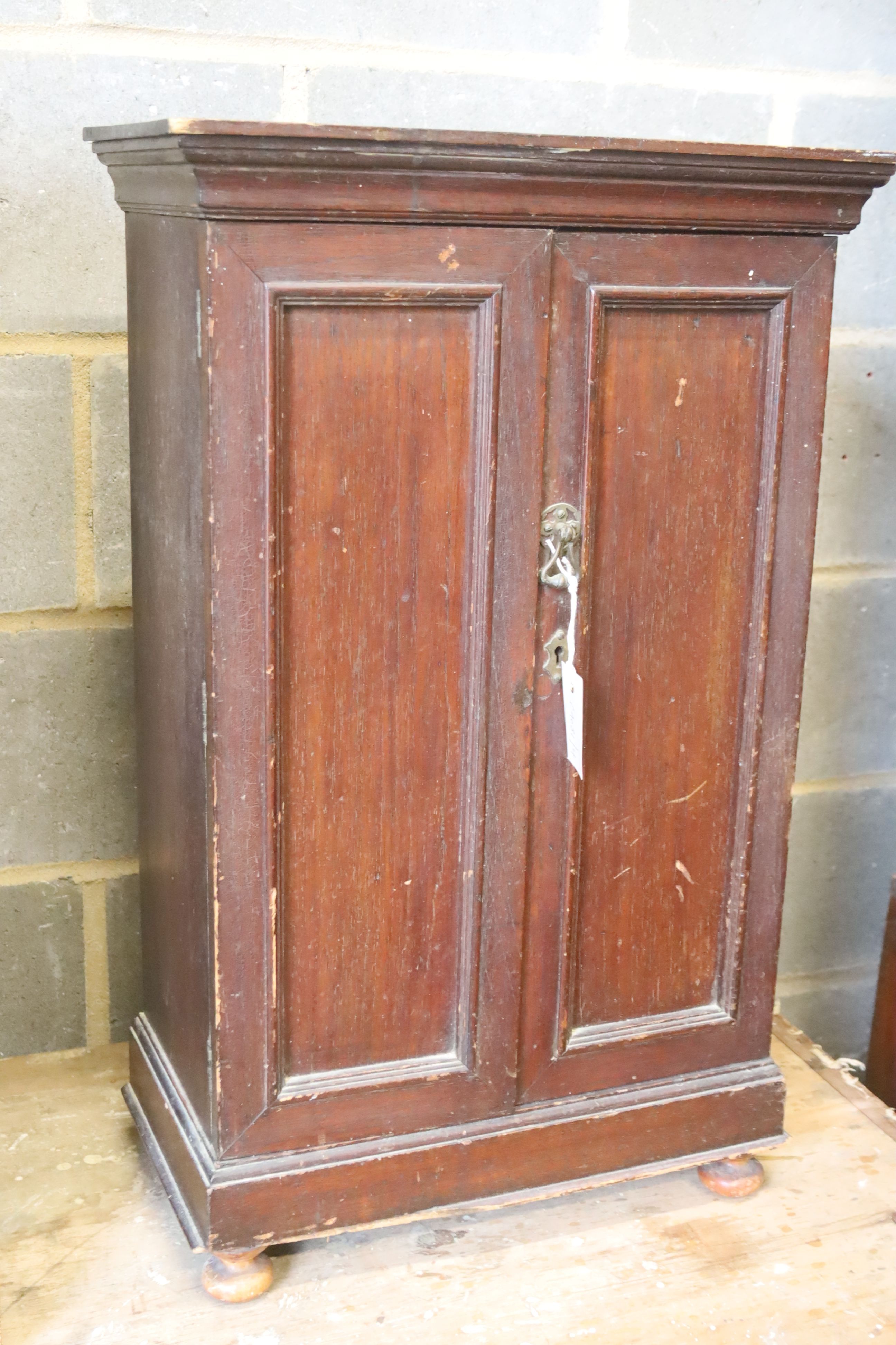 A small late Victorian mahogany two door cabinet, width 47cm, depth 26cm, height 76cm